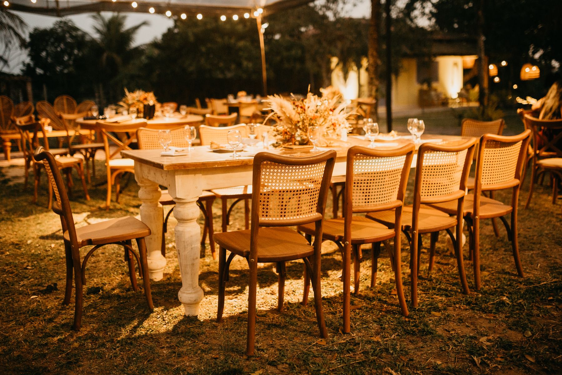 Reception tables under warm lights at dusk